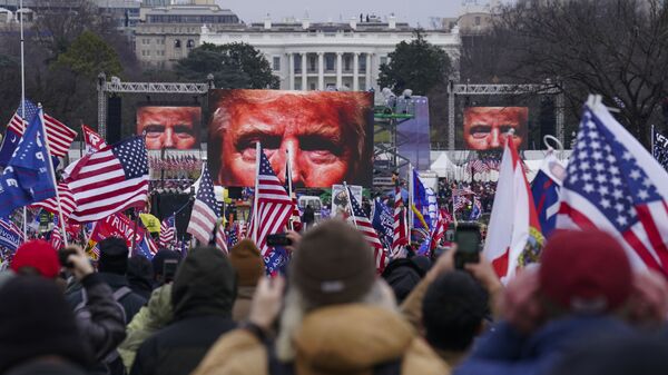 In this Jan. 6, 2021 file photo, Trump supporters participate in a rally in Washington.  An AP review of records finds that members of President Donald Trump’s failed campaign were key players in the Washington rally that spawned a deadly assault on the U.S. Capitol last week. - Sputnik International