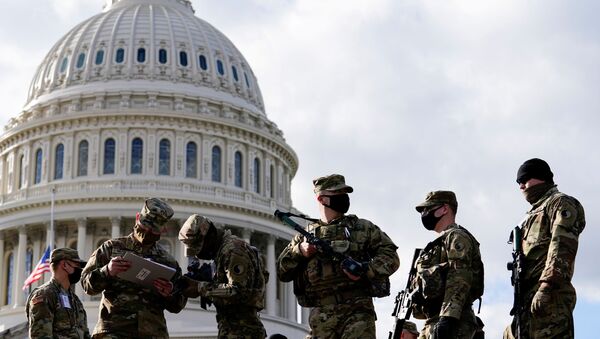 National Guard troops receive guns and ammunition outside the U.S. Capitol building as supporters of U.S. President Donald Trump are expected to protest against the election of President-elect Joe Biden, in Washington DC, U.S. January 17, 2021 - Sputnik International