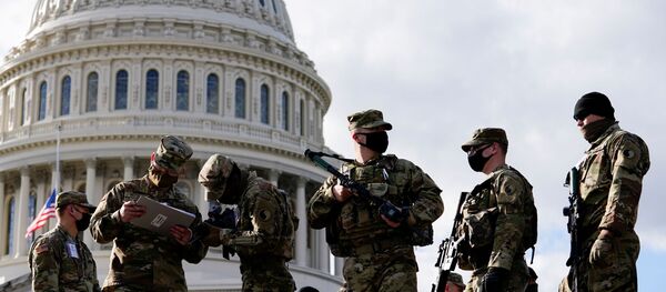 National Guard troops receive guns and ammunition outside the U.S. Capitol building as supporters of U.S. President Donald Trump are expected to protest against the election of President-elect Joe Biden, in Washington DC, U.S. January 17, 2021 - Sputnik International