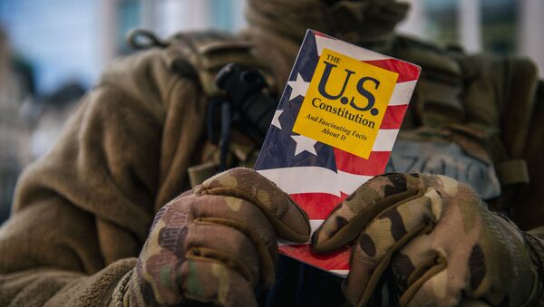 WASHINGTON, DC - JANUARY: 17 National Guard Master Sergeant George Roachs holds up a pamphlet of the U.S. Constitution on January 17, 2021 in Washington, DC.  - Sputnik International