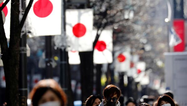 Pedestrians wearing protective masks, amid the coronavirus disease (COVID-19) outbreak, make their way at Ginza shopping district which closed to cars on Sunday in Tokyo, Japan, January 10, 2021. REUTERS/Kim Kyung-Hoon - Sputnik International