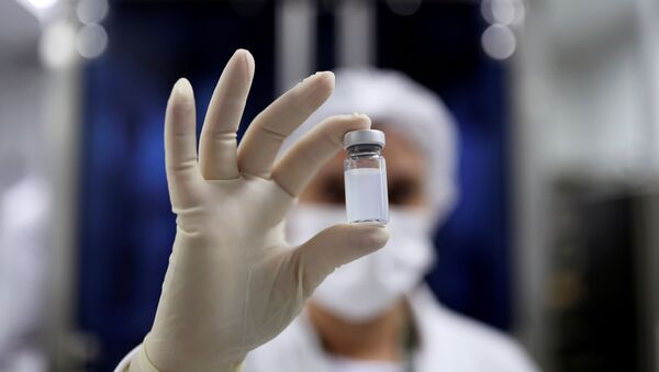 An employee holds a vial containing CoronaVac, Sinovac Biotech's vaccine against the coronavirus disease (COVID-19) - Sputnik International