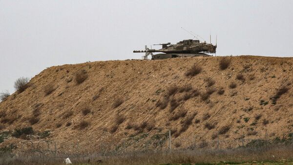 An Israeli tank is pictured on Israel's border with Gaza, opposite the Palestinilan city of Khan Yunis in the southern Gaza Strip, on January 13, 2021. - Sputnik International