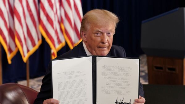 U.S. President Donald Trump shows signed executive orders for economic relief at his golf resort in Bedminster, New Jersey, U.S., August 8, 2020. - Sputnik International
