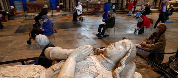 People wait to receive the coronavirus disease (COVID-19) vaccine at a vaccination centre inside the Salisbury Cathedral, in Salisbury, Britain January 20, 2021 - Sputnik International