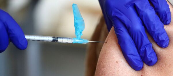 A health worker receives an injection with a dose of the Pfizer-BioNTech COVID-19 vaccine, amid the coronavirus disease (COVID-19) outbreak, at Fuentelarreina primary healthcare centre in Madrid, Spain January 18, 2021. A health worker receives an injection with a dose of the Pfizer-BioNTech COVID-19 vaccine, amid the coronavirus disease (COVID-19) outbreak, at Fuentelarreina primary healthcare centre in Madrid, Spain January 18, 2021. - Sputnik International