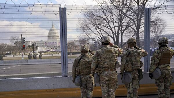 National Guard members salute in front of the U.S. Capitol building during the inauguration of President-elect Joe Biden in Washington, U.S., January 20, 2021.  - Sputnik International