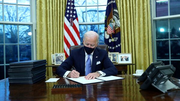 U.S. President Joe Biden signs executive orders in the Oval Office of the White House in Washington, after his inauguration as the 46th President of the United States, U.S., January 20, 2021. - Sputnik International
