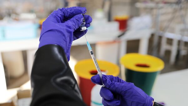 A medical worker prepares to administer a vaccination against the coronavirus disease (COVID-19) as Israel continues its national vaccination campaign amid a third COVID-19 lockdown, at a drive-through vaccination centre in Haifa, Israel January 6, 2021.  - Sputnik International