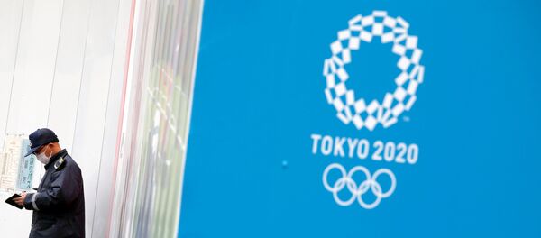 A security officer stands next to the Tokyo 2020 Olympic Games logo, amid the coronavirus disease (COVID-19) outbreak in Tokyo, Japan December 24, 2020. - Sputnik International