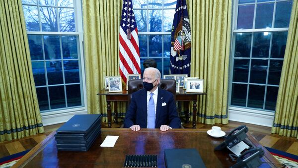 U.S. President Joe Biden signs executive orders in the Oval Office of the White House in Washington, after his inauguration as the 46th President of the United States, U.S., January 20, 2021. - Sputnik International