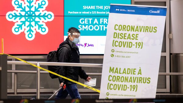 A man walks through terminal 3, amid a spike in coronavirus disease (COVID-19) cases, at Pearson airport near Toronto, Ontario, Canada December 30, 2020.  - Sputnik International
