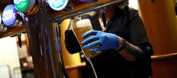 FILE PHOTO: A worker serves a beer at The Holland Tringham Wetherspoons pub after it reopened following the outbreak of the coronavirus disease (COVID-19), in London, Britain July 4, 2020 - Sputnik International