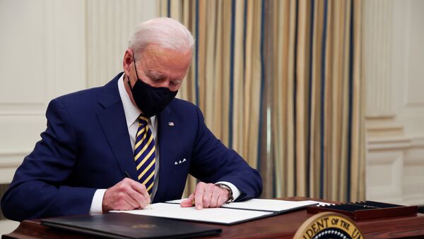 U.S. President Joe Biden and signs an executive order after speaking about his administration's plans to respond to the economic crisis during a coronavirus disease (COVID-19) response event in the State Dining Room at the White House in Washington, U.S., January 22, 2021. - Sputnik International