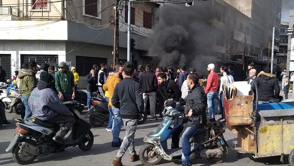 Smoke rises as demonstrators protest against the lockdown and worsening economic conditions, amid the spread of the coronavirus disease (COVID-19), in Tripoli - Sputnik International