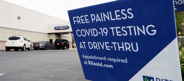 Vehicles line up at a self-swabbing coronavirus disease (COVID-19) test at a Rite Aid drive-thru during the outbreak of COVID-19, in Pasadena, California, U.S., January 22, 2021 - Sputnik International