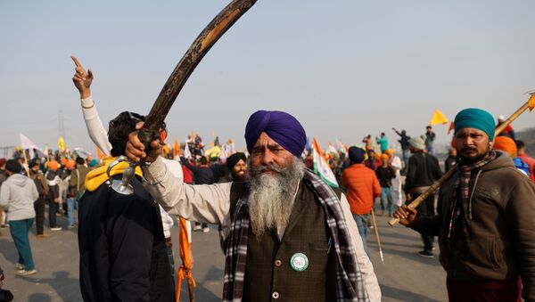A farmer holding a sword looks on after police stopped farmers as they take part in a tractor rally to protest against farm laws on the occasion of India's Republic Day in Delhi, India, January 26, 2021 - Sputnik International