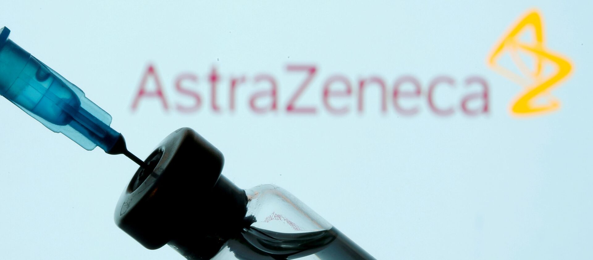 FILE PHOTO: A vial and syringe are seen in front of a displayed AstraZeneca logo in this illustration taken January 11, 2021 - Sputnik International, 1920, 01.02.2021