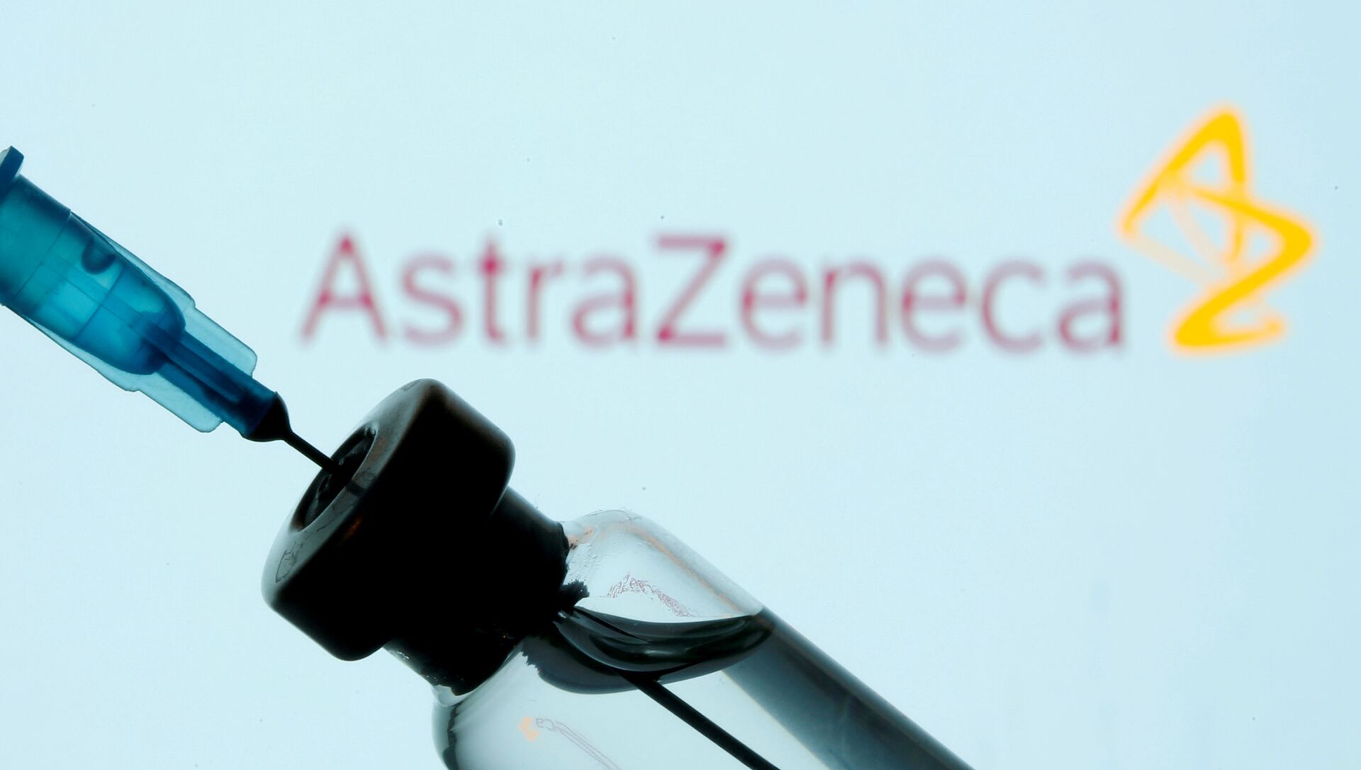 FILE PHOTO: A vial and syringe are seen in front of a displayed AstraZeneca logo in this illustration taken January 11, 2021 - Sputnik International, 1920, 11.02.2021
