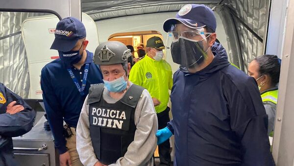 In this photo released by the Colombian Migration Press Office, ex-paramilitary commander Hernan Giraldo Serna, center, is escorted upon arrival at the El Dorado airport after being deported from the U.S. to Bogota, Colombia, Monday, Jan. 25, 2021. Giraldo, 74, was deported from the U.S. and immediately taken into custody by authorities in Colombia, where he is expected to serve time for crimes against humanity, including torture, displacement, sexual slavery and kidnapping, as well as drug trafficking - Sputnik International