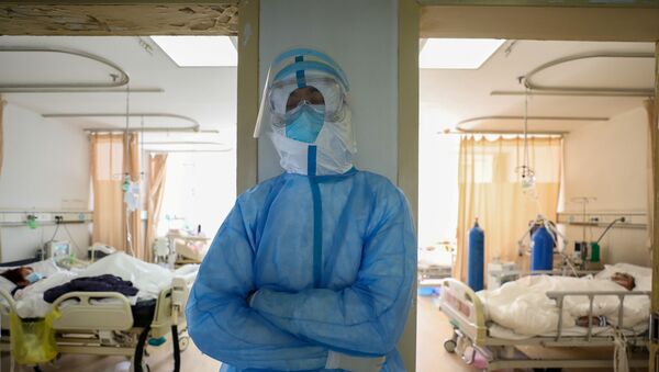 FILE PHOTO: A medical worker in protective suit takes a break at an isolated ward of Wuhan Red Cross Hospital in Wuhan, the epicentre of the novel coronavirus outbreak, in Hubei province, China February 16, 2020 - Sputnik International