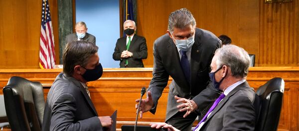 Sen. Joe Manchin (D-W.Va.) speaks to Sens. Martin Heinrich (D-N.M.) and Tim Kaine (D-Va.) prior to President-elect Joe Biden's nominee for Secretary of Defense Retired Army Gen. Lloyd Austin confirmation hearing before the Senate Armed Services Committee in Washington, U.S. January 19, 2021 Sen. Joe Manchin (D-W.Va.) speaks to Sens. Martin Heinrich (D-N.M.) and Tim Kaine (D-Va.) prior to President-elect Joe Biden's nominee for Secretary of Defense Retired Army Gen. Lloyd Austin confirmation hearing before the Senate Armed Services Committee in Washington, U.S. January 19, 2021 - Sputnik International
