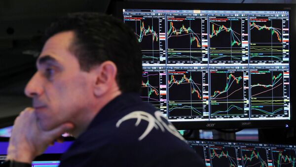 A trader at the New York Stock Exchange works as markets continue to react to the coronavirus disease (COVID-19) inside of the NYSE in New York, U.S., March 18, 2020 - Sputnik International