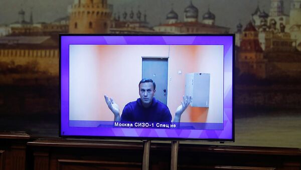 Russian opposition leader Alexei Navalny is seen on a screen via a video link during a court hearing to consider an appeal on his arrest outside Moscow, Russia January 28, 2021 - Sputnik International