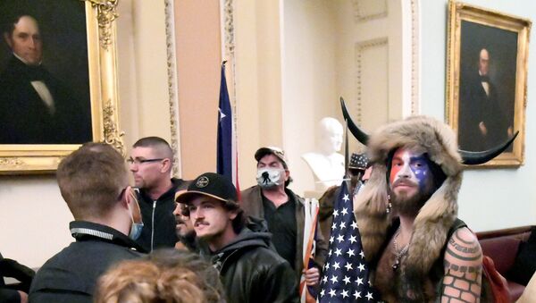 Jacob Anthony Chansley, also known as Jake Angeli, of Arizona, stands with other supporters of U.S. President Donald Trump as they demonstrate on the second floor of the U.S. Capitol near the entrance to the Senate after breaching security defenses, in Washington, U.S., January 6, 2021.          - Sputnik International