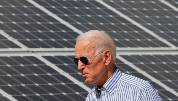  Democratic 2020 U.S. presidential candidate and former Vice President Joe Biden walks past solar panels while touring the Plymouth Area Renewable Energy Initiative in Plymouth, New Hampshire, U.S., June 4, 2019.   - Sputnik International