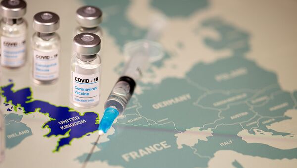FILE PHOTO: Vials labelled COVID-19 Coronavirus-Vaccine and medical syringe are placed on the European Union map in this picture illustration taken December 2, 2020. - Sputnik International