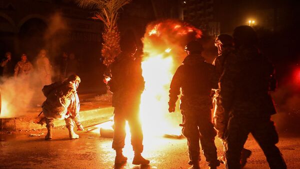 Members of the Lebanese army stand near burning tires during a protest against the lockdown and worsening economic conditions, amid the spread of the coronavirus disease (COVID-19), in Tripoli, Lebanon January 29, 2021. - Sputnik International