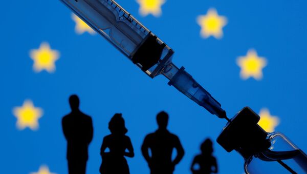 A vial, sryinge and small toy figures are seen in front of a displayed EU flag in this illustration taken January 11, 2021.  - Sputnik International
