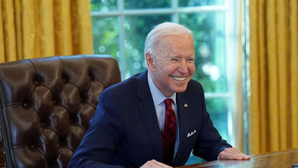 U.S. President Joe Biden smiles after signing executive orders strengthening access to affordable healthcare at the White House in Washington, U.S., January 28, 2021 - Sputnik International