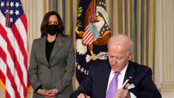 U.S. Vice President Kamala Harris watches as President Joe Biden signs executive orders on his racial equity agenda at the White House in Washington, U.S., January 26, 2021 - Sputnik International