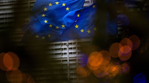 European Union flags flutter in the wind outside EU headquarters in Brussels, Saturday, Dec. 19, 2020 - Sputnik International