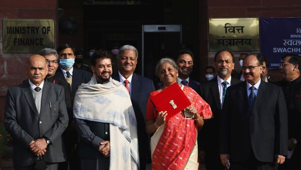 India's Finance Minister Nirmala Sitharaman holds up a folder with the Government of India logo, as India's Chief Economic Advisor Krishnamurthy Subramanian and Minister of State for Finance and Corporate Affairs Anurag Thakur look on as she leaves her office to present the federal budget in the parliament in New Delhi - Sputnik International