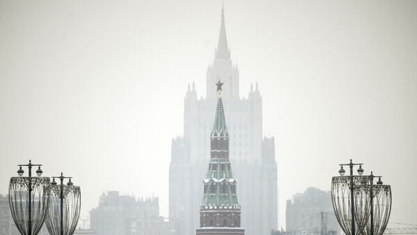 A man walks along a bridge in front of a Kremlin tower and the Russian Foreign Ministry building on the background in downtown Moscow on January 12, 2021. - Sputnik International