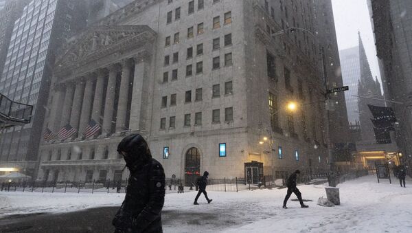 People walk past the New York Stock Exchange during a snowstorm, Monday, Feb. 1, 2021, in New York.  - Sputnik International