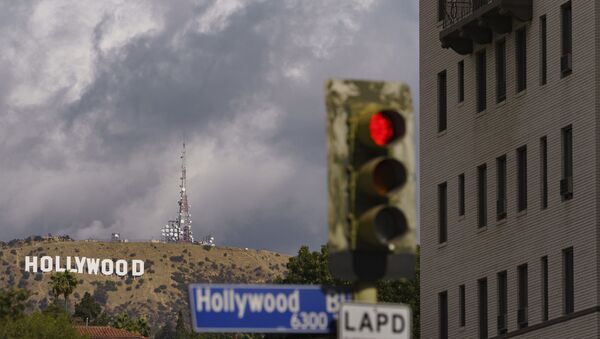 In this Nov. 7, 2020, file photo, clouds move over the Hollywood sign in Los Angeles. The raging coronavirus pandemic has prompted Los Angeles County to impose a lockdown to prevent the caseload from spiraling into a hospital crisis but the order stops short of a full business shutdown that could cripple the holiday sale season. - Sputnik International