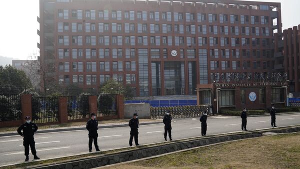 Security personnel gather near the entrance to the Wuhan Institute of Virology during a visit by a World Health Organisation team to Wuhan in China's Hubei province on Wednesday, 3 February 2021.  - Sputnik International