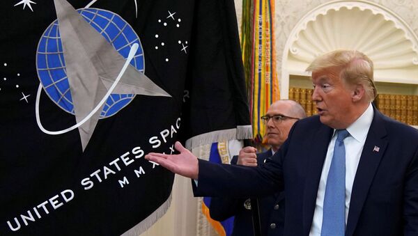 FILE PHOTO: Trump gestures towards the U.S. Space Force flag during its presentation at the White House in Washington - Sputnik International