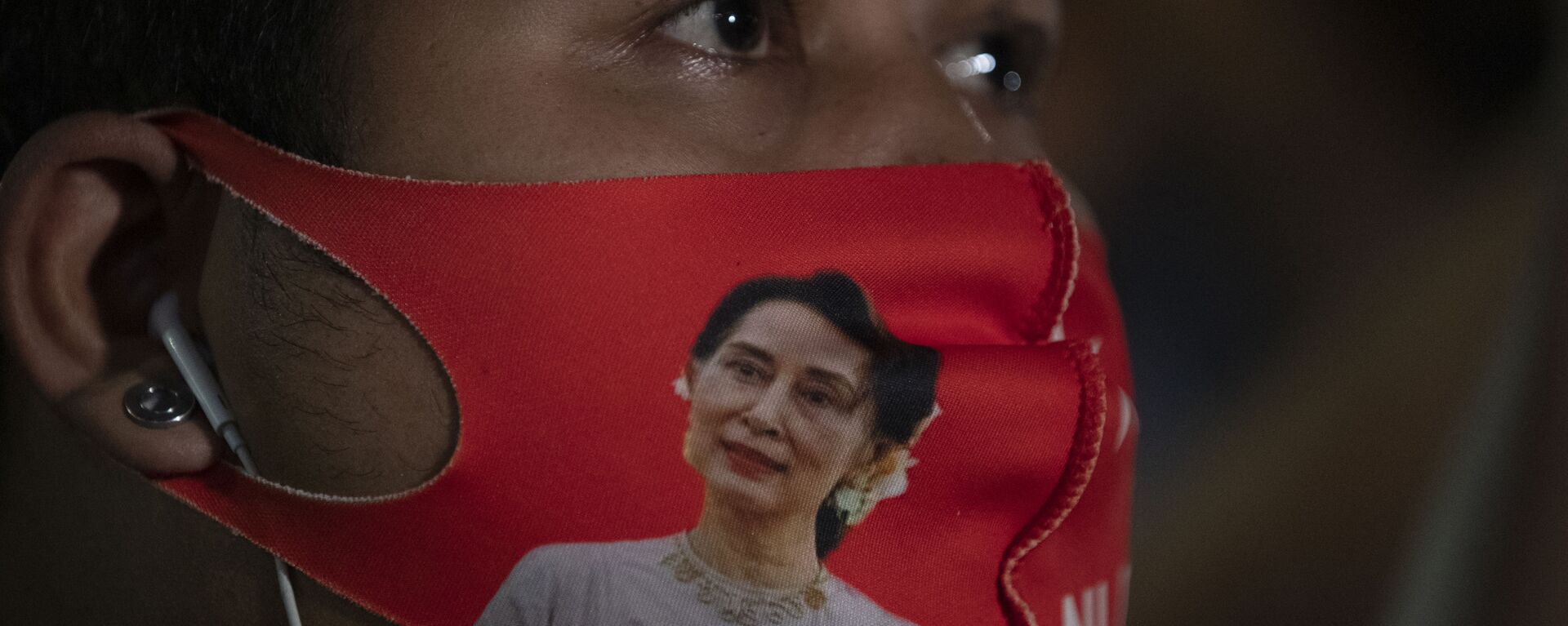 A Myanmar national living in Thailand wears a face mask with the image of Myanmar leader Aung San Suu Kyi during a protest in front of Myanmar Embassy in Bangkok, Thailand, Thursday, Feb. 4, 2021. The military announced Monday that it will take power for one year, accusing Suu Kyi's government of not investigating allegations of voter fraud in recent elections. Suu Kyi's party swept that vote and the military-backed party did poorly. The state Election Commission has refuted the allegations. - Sputnik International, 1920, 16.02.2021