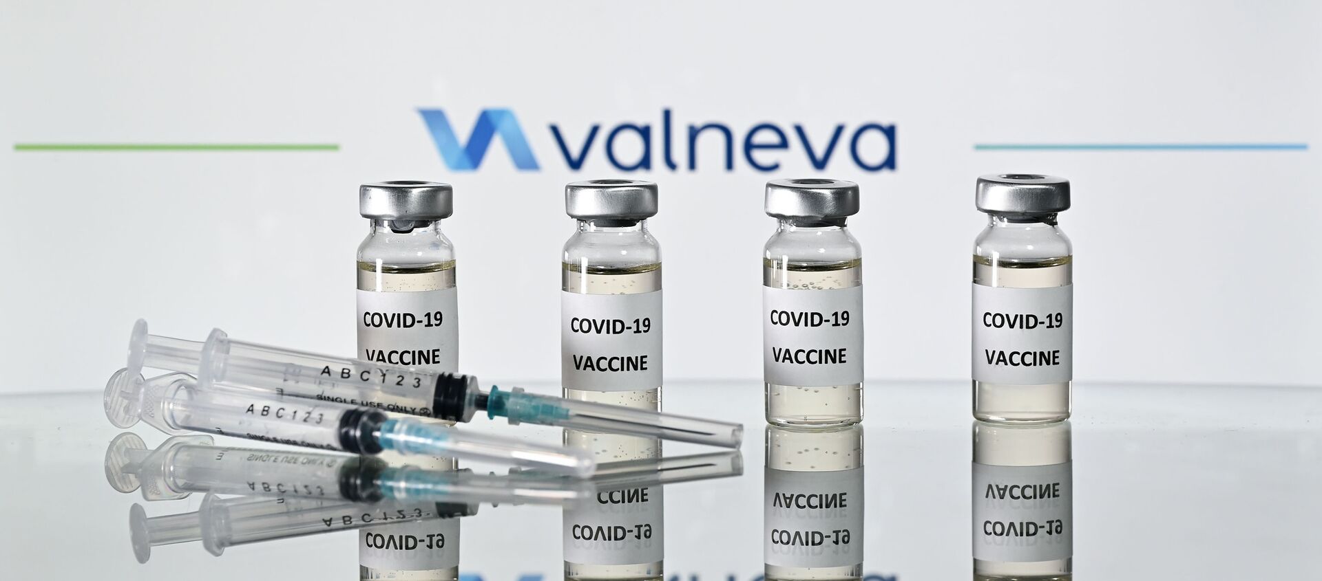 An illustration picture shows vials with Covid-19 Vaccine stickers attached and syringes with the logo of French-Austrian vaccine firm Valneva on November 17, 2020.  - Sputnik International, 1920, 05.02.2021