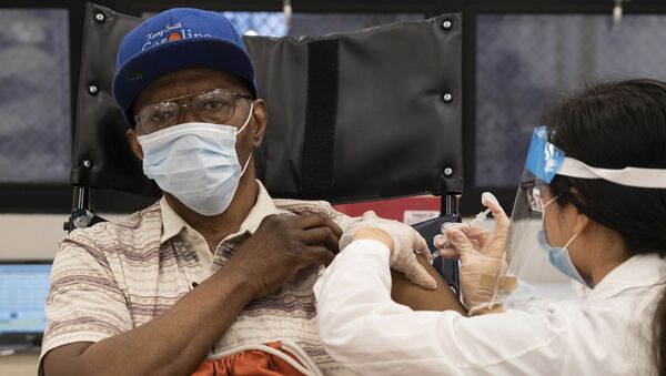  In this Jan. 15, 2021, file photo, a nursing home resident receives the COVID-19 vaccine by a CVS Pharmacist at Harlem Center for Nursing and Rehabilitation, a nursing home facility in Harlem neighborhood of New York.  - Sputnik International
