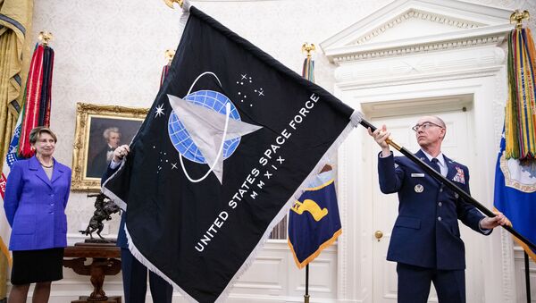 Chief Master Sgt. Roger Towberman (R), Space Force and Command Senior Enlisted Leader and CMSgt Roger Towberman (L), with Secretary of the Air Force Barbara Barrett present US President Donald Trump with the official flag of the United States Space Force in the Oval Office of the White House in Washington, DC on May 15, 2020. - Sputnik International