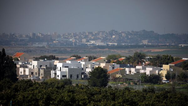 A general view shows an Israeli village in the foreground and part of the Gaza Strip, as it is seen from the Israeli side of the Israel- Gaza border February 6, 2021. REUTERS/Amir Cohen - Sputnik International