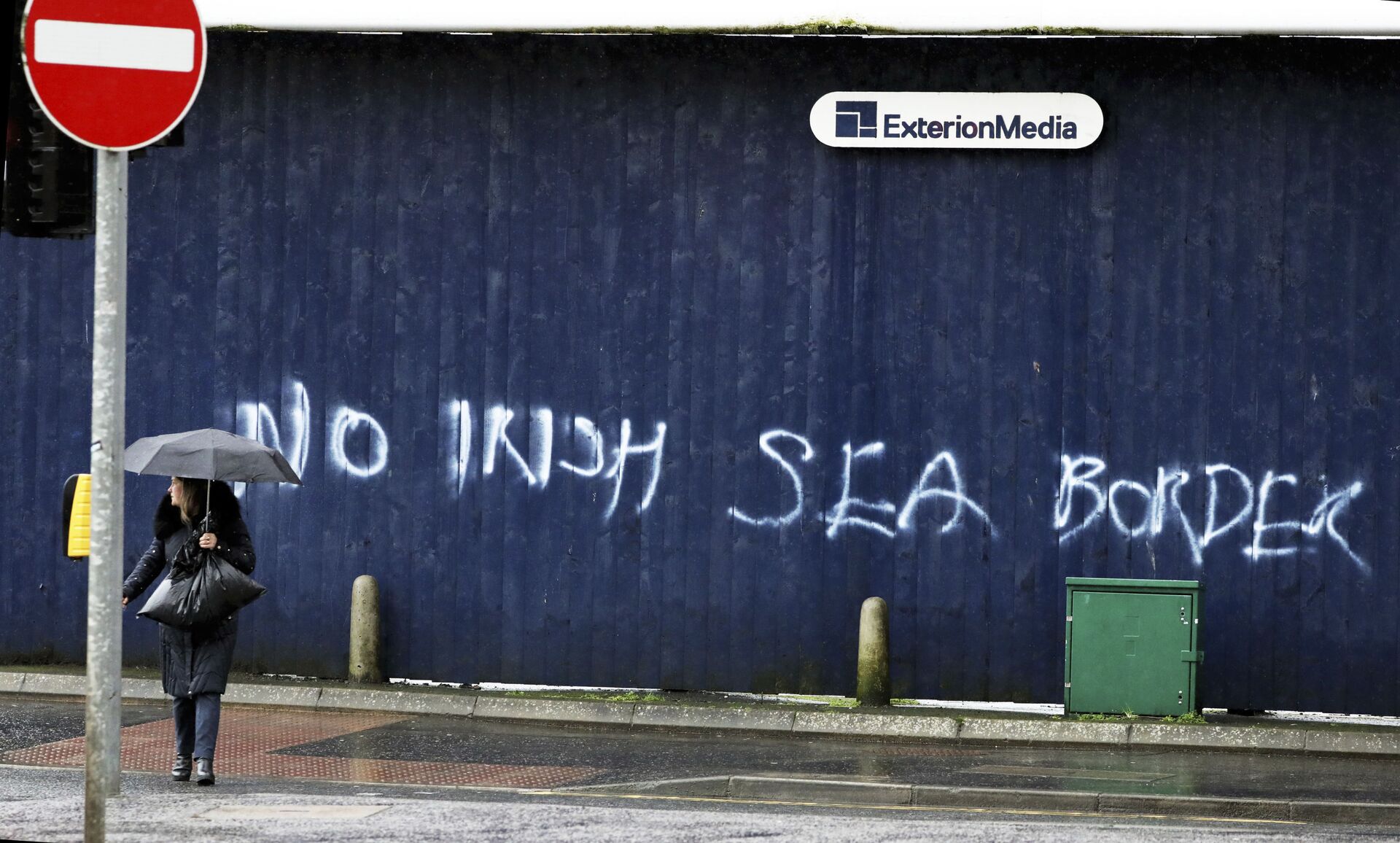 A woman walks past past graffiti with the words 'No Irish Sea Border' in Belfast city centre, Northern Ireland, Wednesday, Feb. 3, 2021 - Sputnik International, 1920, 13.10.2021