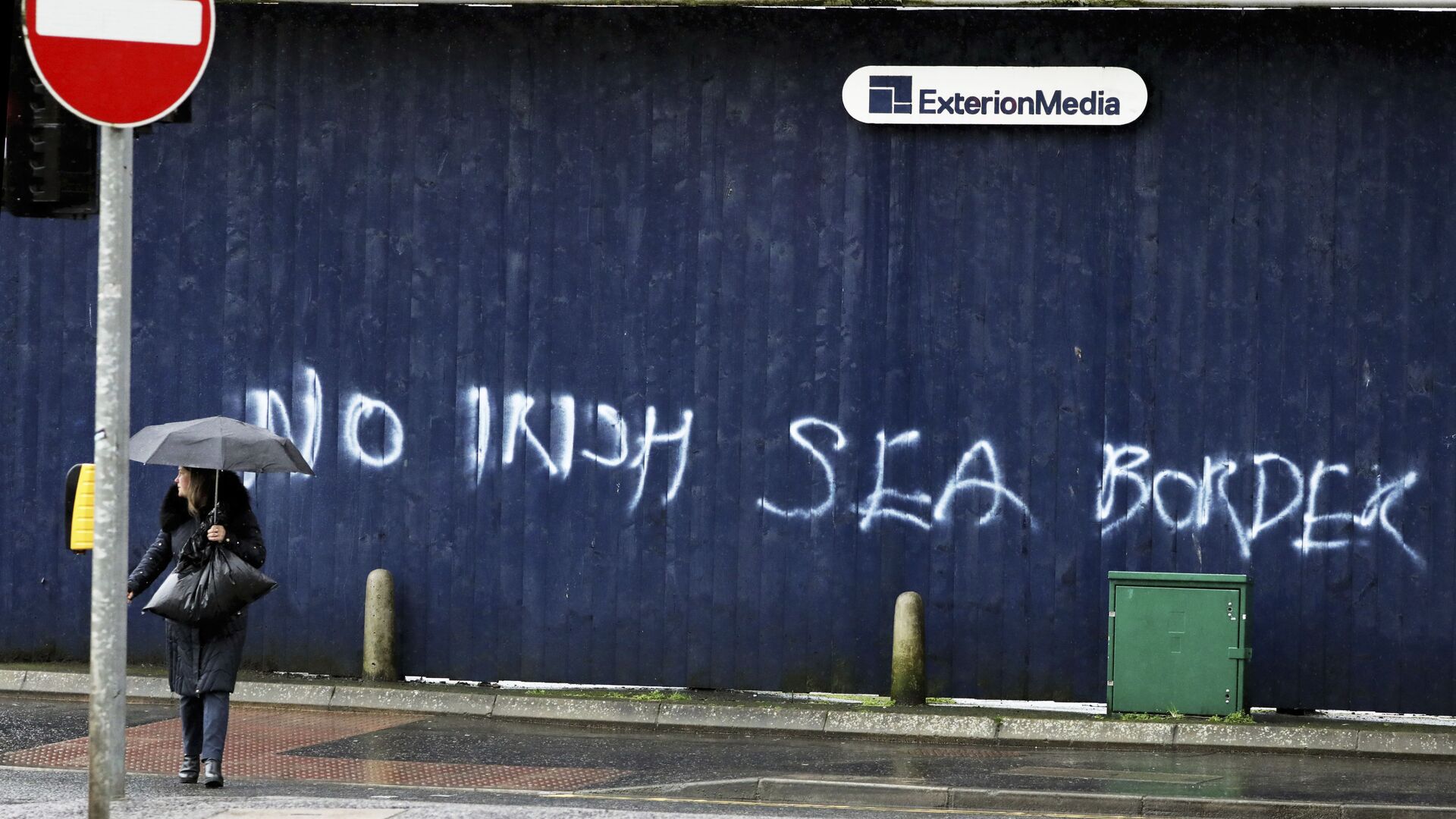 A woman walks past past graffiti with the words 'No Irish Sea Border' in Belfast city centre, Northern Ireland, Wednesday, Feb. 3, 2021 - Sputnik International, 1920, 12.02.2021