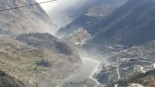 This frame grab from video provided by KK Productions shows a massive flood of water, mud and debris flowing at Chamoli District after a portion of Nanda Devi glacier broke off in Tapovan area of the northern state of Uttarakhand, India, Sunday, Feb.7, 2021. (KK Productions via AP) - Sputnik International
